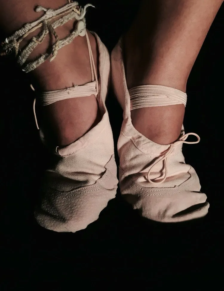 Close-up conceptual photograph of bound feet