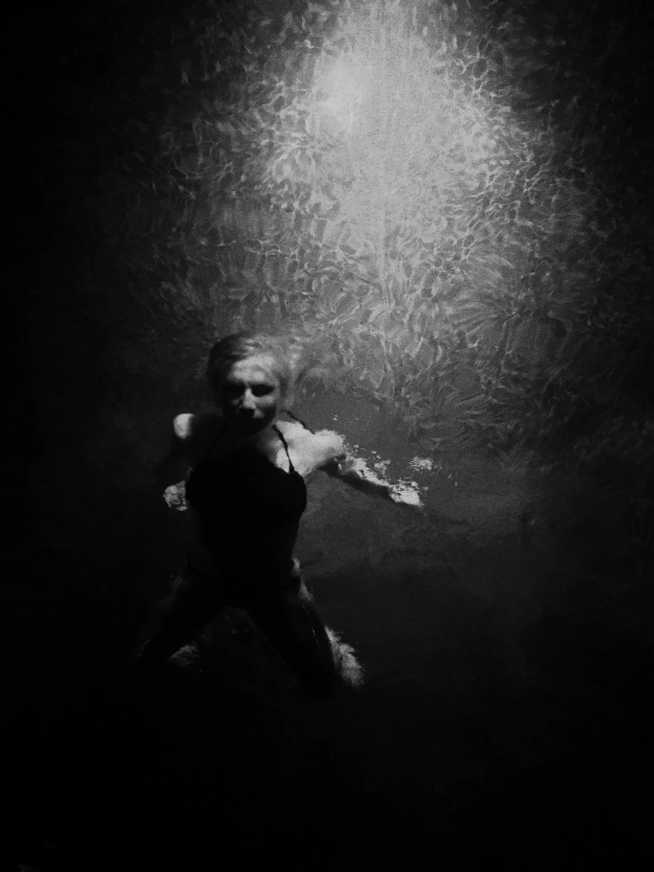 Figure illuminated against a dark textured background